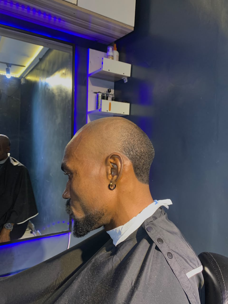 Close-shaven haircut and neatly shaped facial hair